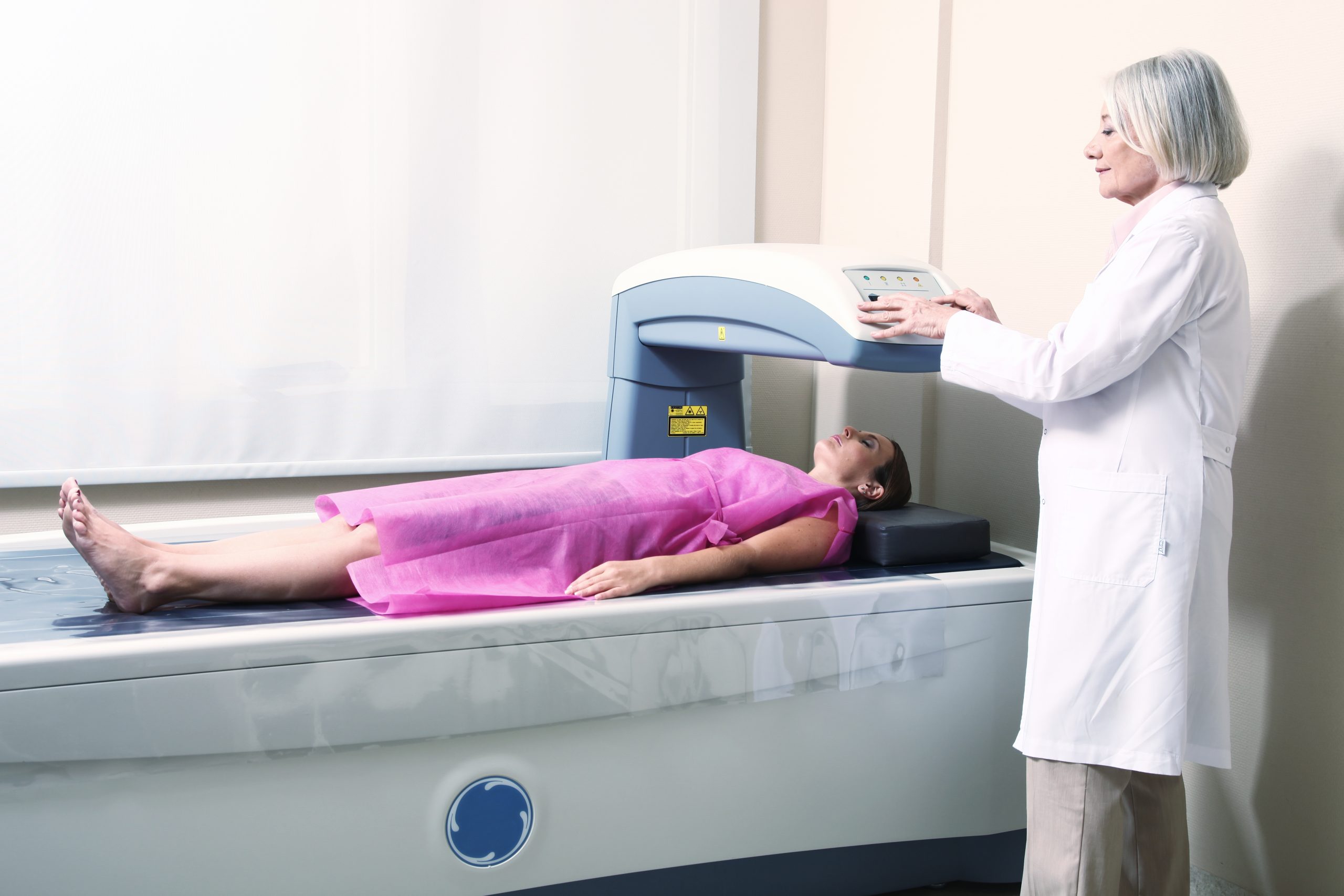 Bone Mineral Density (BMD) calculator - Woman Receiving Dexa-scan with providers-scaled